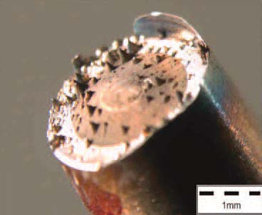 Laser material removal with low laser fluence