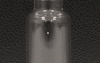 Leak hole in a glass vial